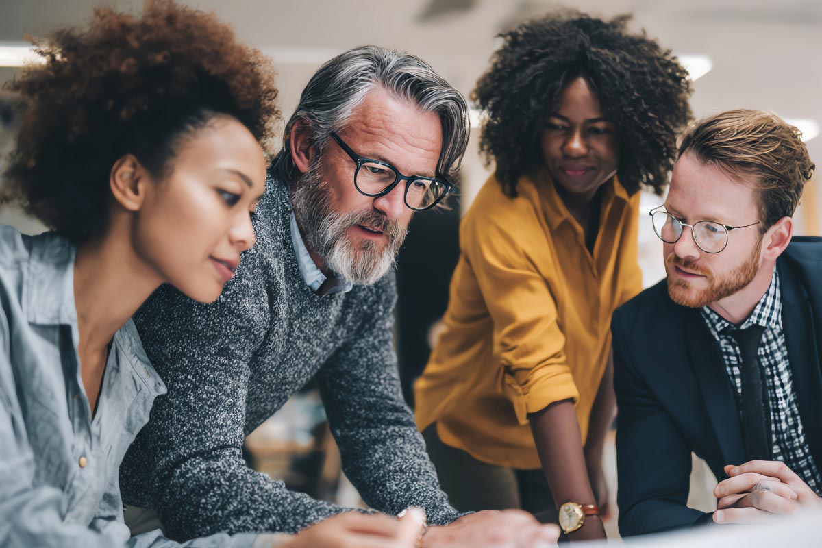 Business and technology leaders reviewing IT discovery findings for post-acquisition integration planning