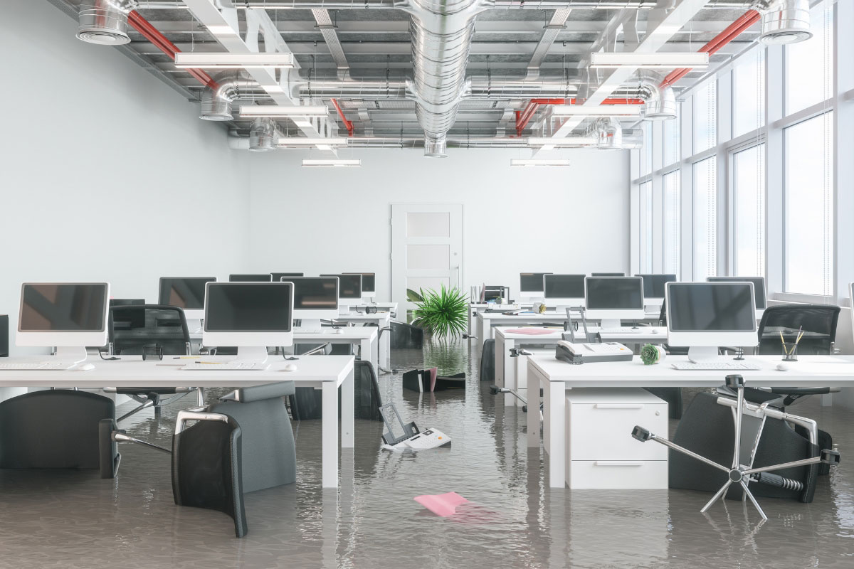 flooded office with damaged computers and equipment