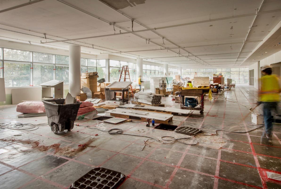 Technicians coordinating network installation and cabling during new site construction.